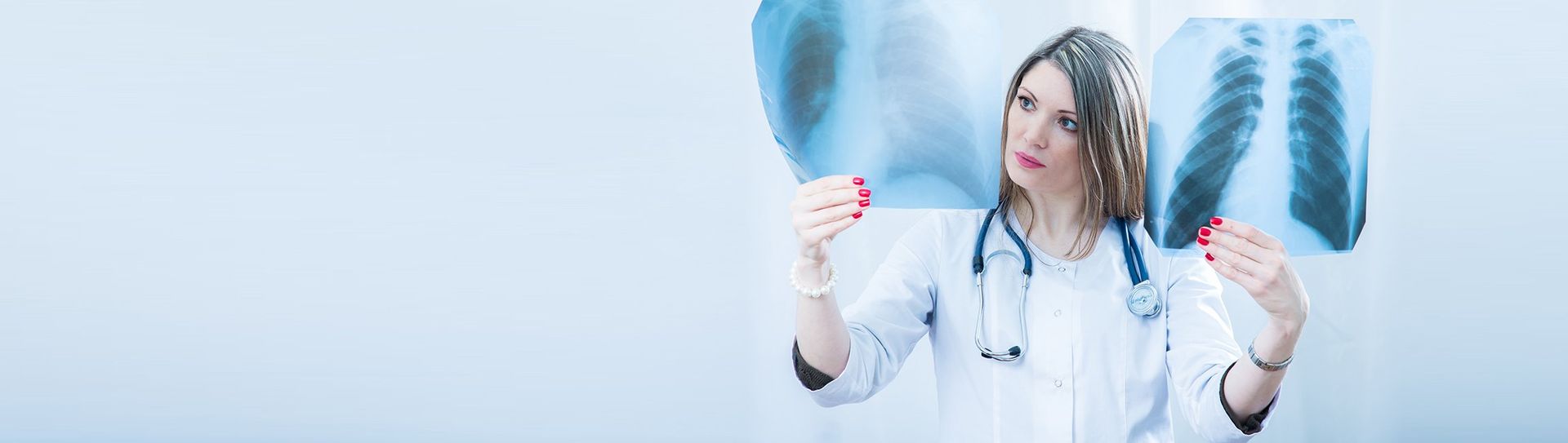 A female doctor is looking at an x-ray of a person 's foot.