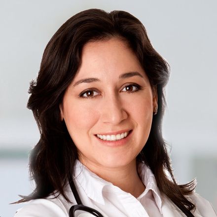 A smiling female doctor with a stethoscope around her neck