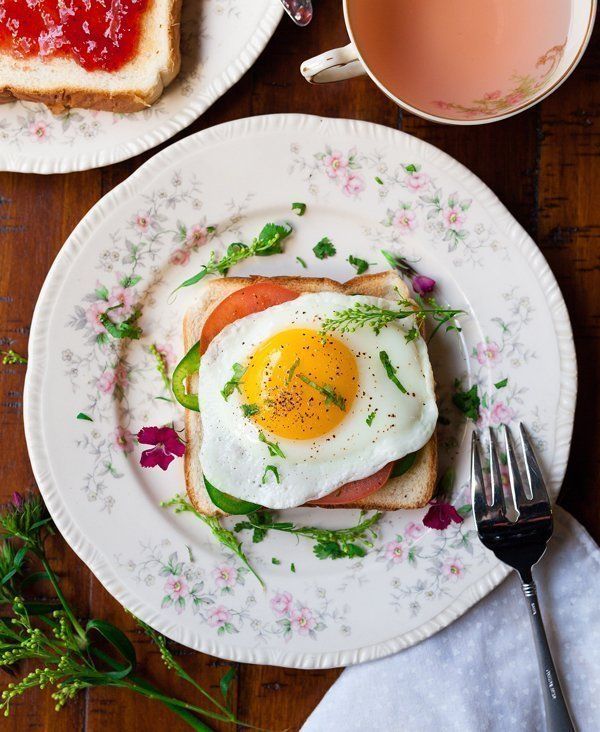 A plate of food with a fried egg on top of a piece of toast.