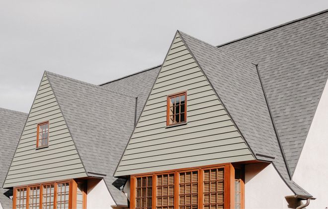 A row of houses with a triangle shaped roof