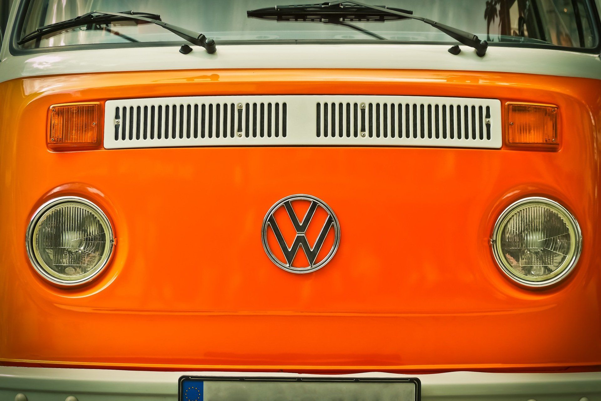 FRont of orange VW camper