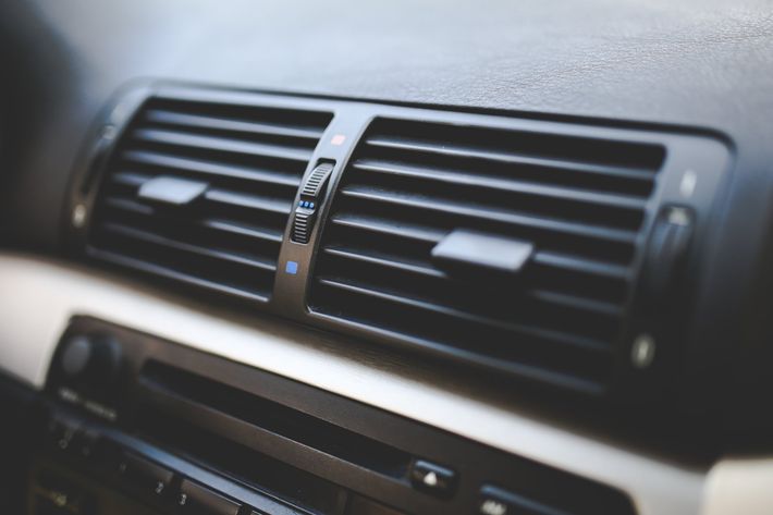 A close up of an air vent in a car