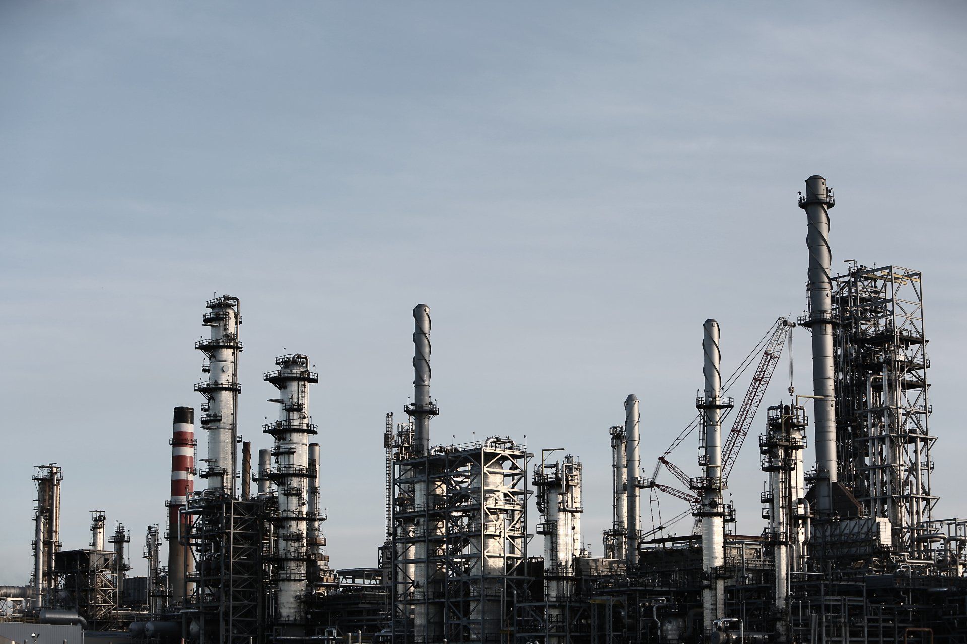 a large oil refinery with a blue sky in the background .