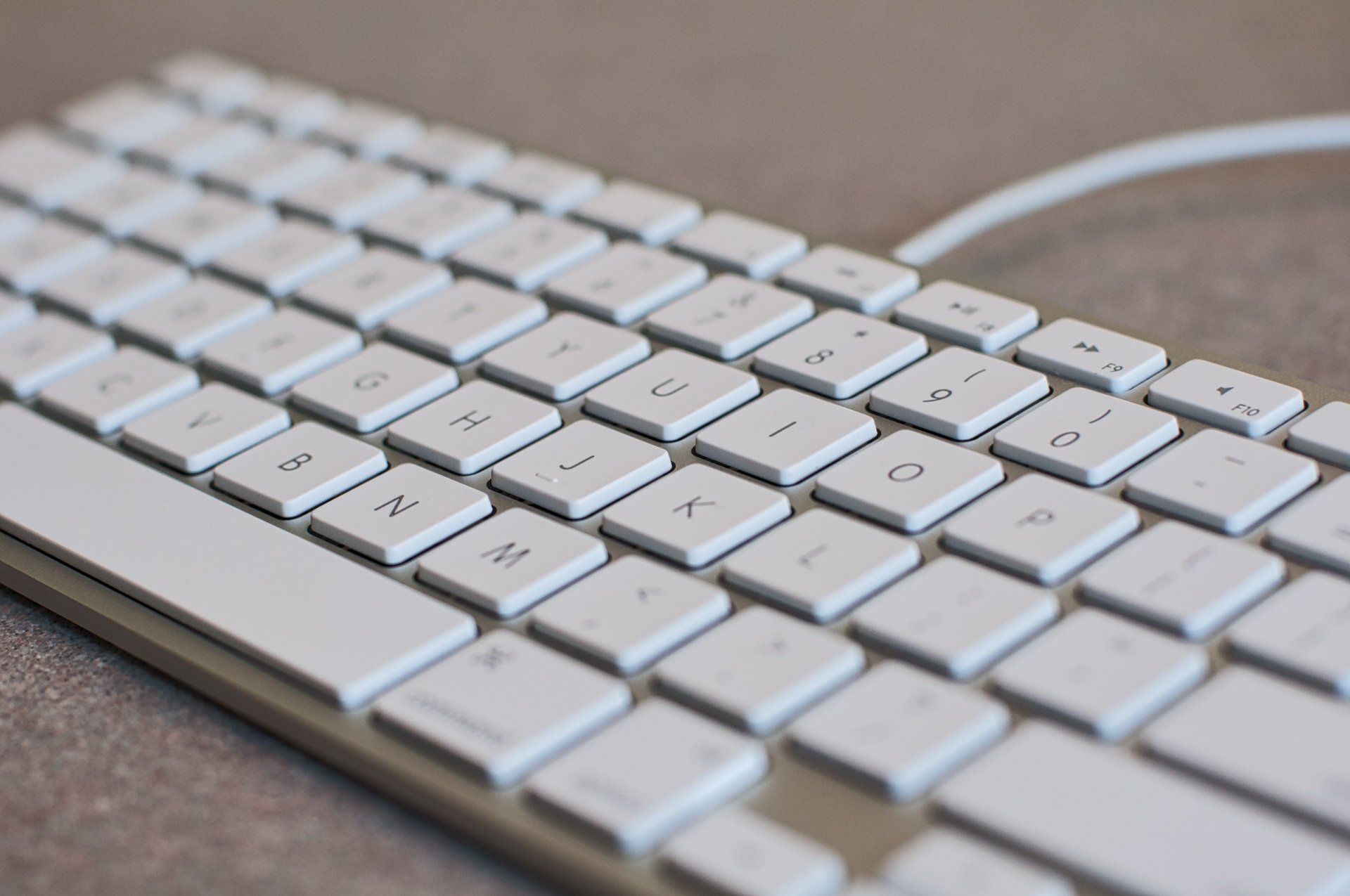 A close up of a white keyboard with a few keys missing
