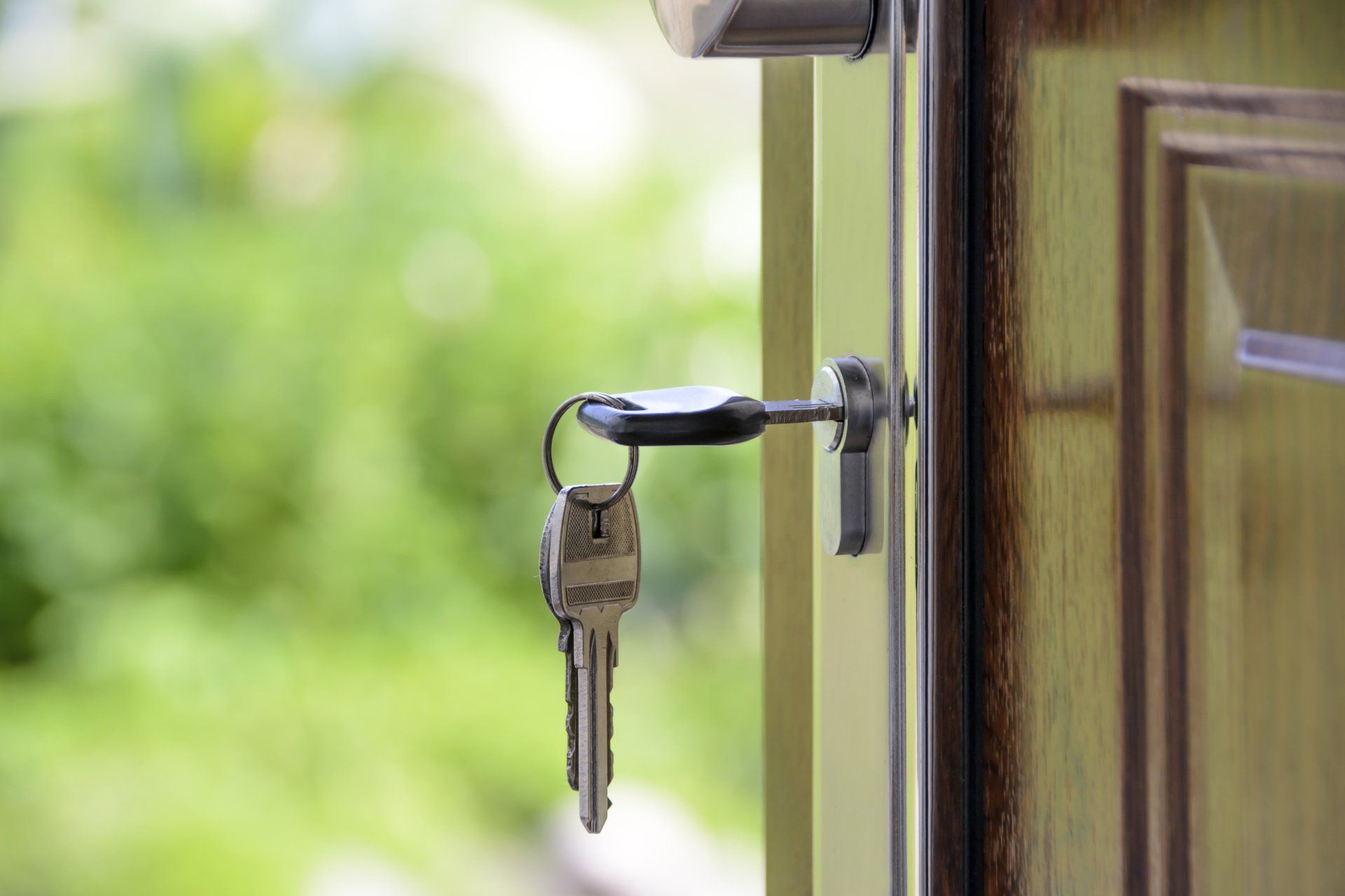 A close up of a door with keys in it.