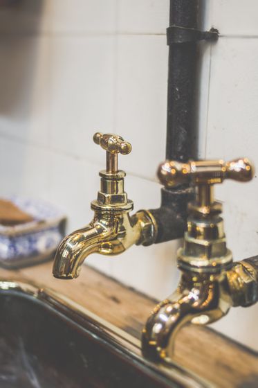 Two Gold Colored Faucets