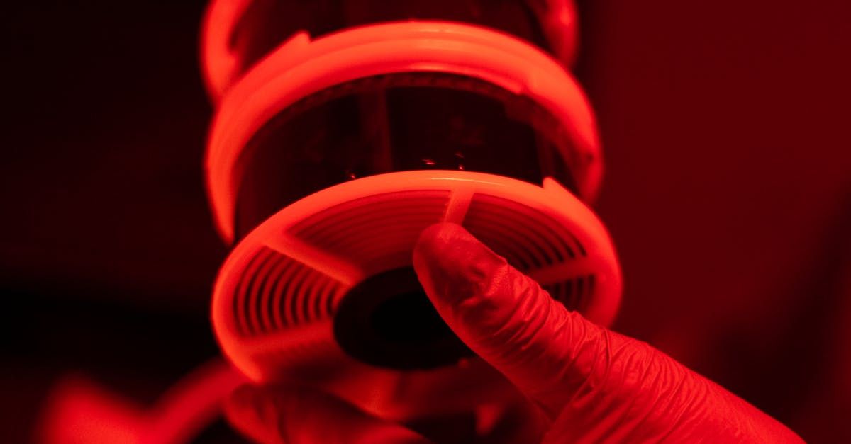 A person is cutting a piece of film with scissors