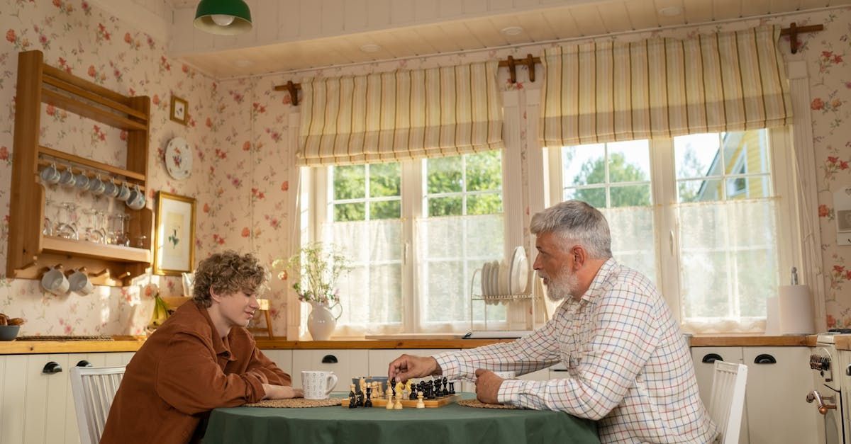 A man and a woman are sitting at a table playing chess.