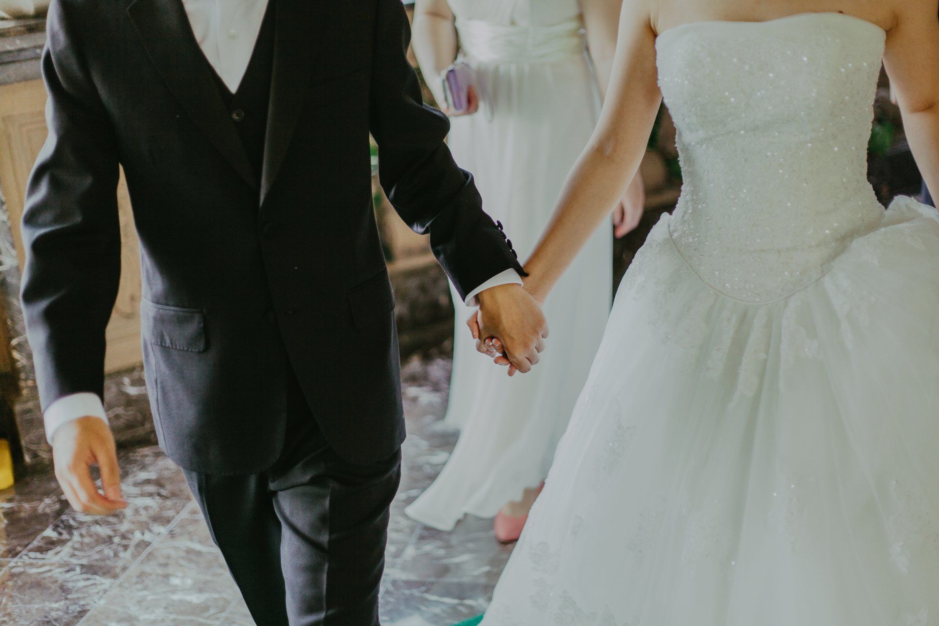 the bride and groom are holding hands during their wedding ceremony