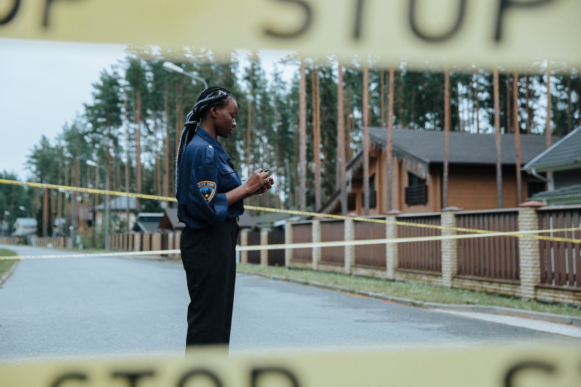A police officer by a taped off crime scene