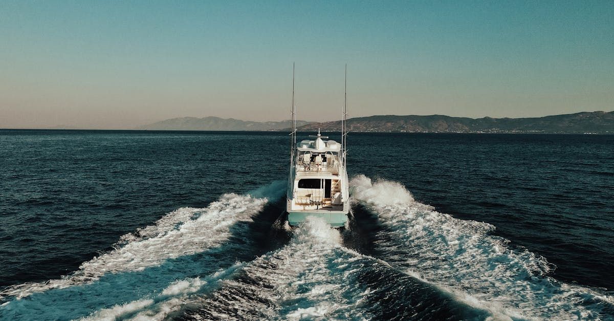 A boat is floating on top of a large body of water.