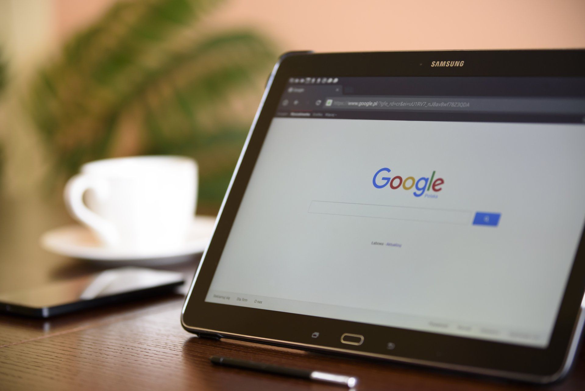 A tablet is open to a google search page on a table.