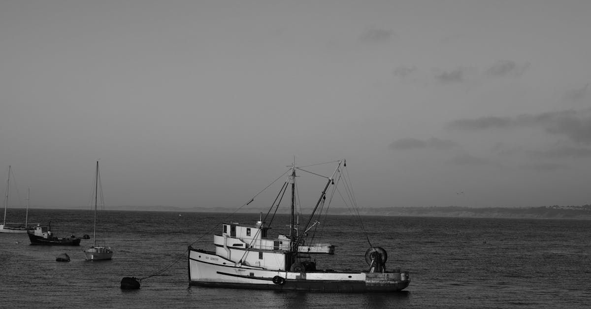 A black and white photo of a boat in the ocean.