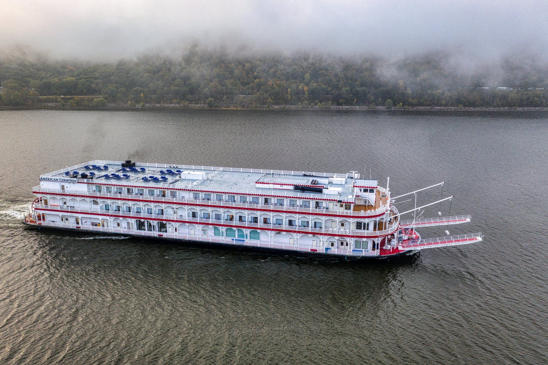 An aerial view of a large cruise ship floating on top of a lake.