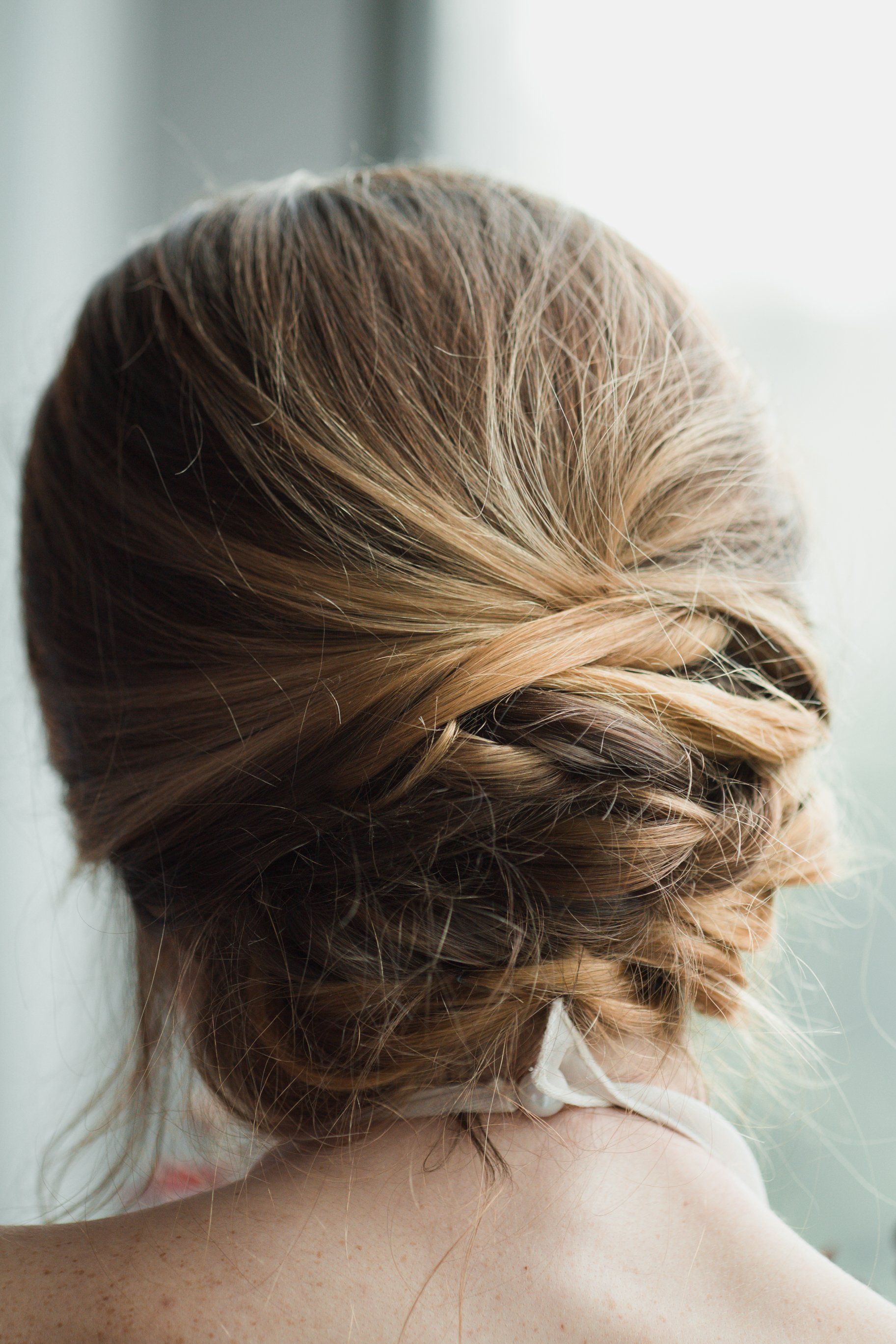 A woman's hair tied up in a bun, perfect for hair tissue mineral analysis (HTMA) tests.