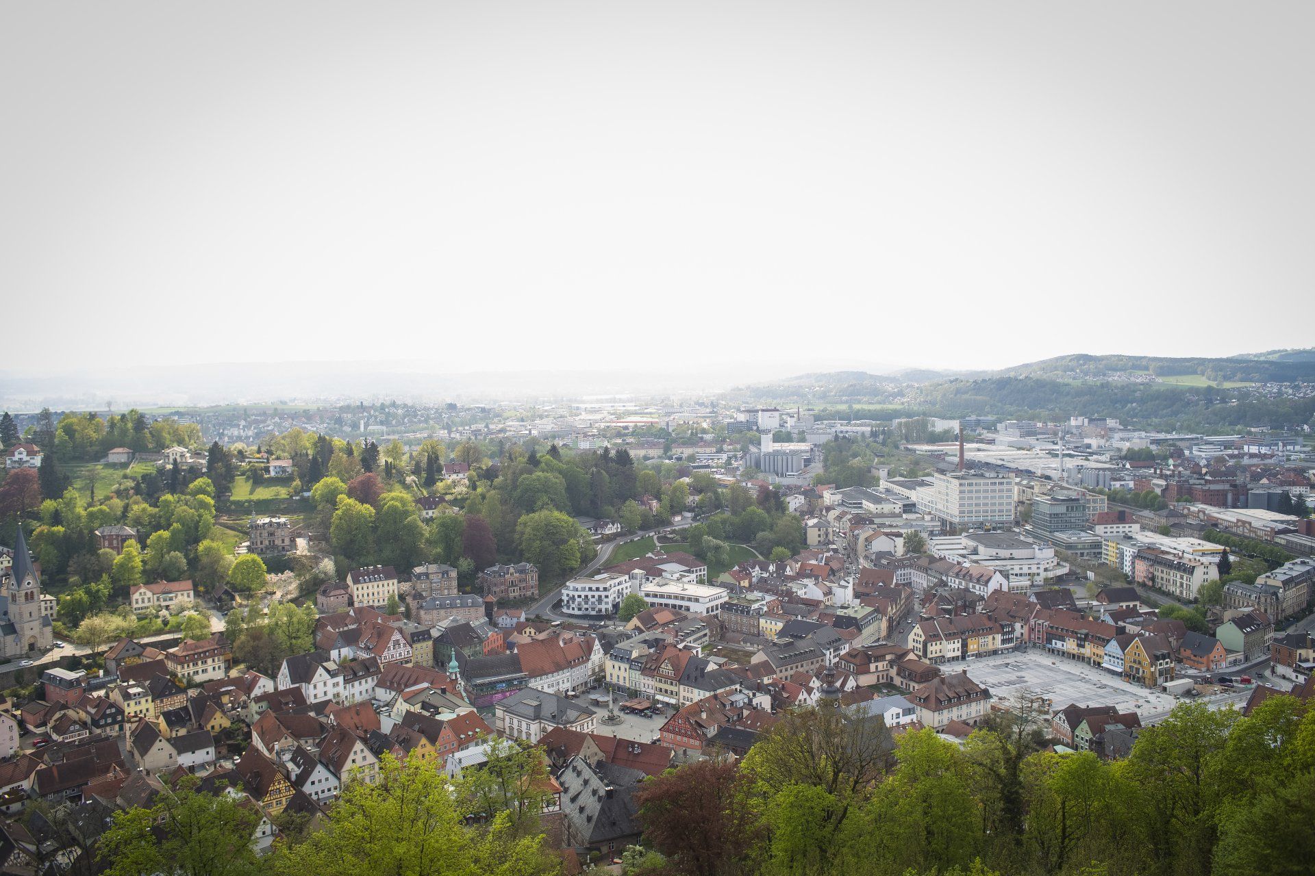 An aerial view of a small town surrounded by trees.