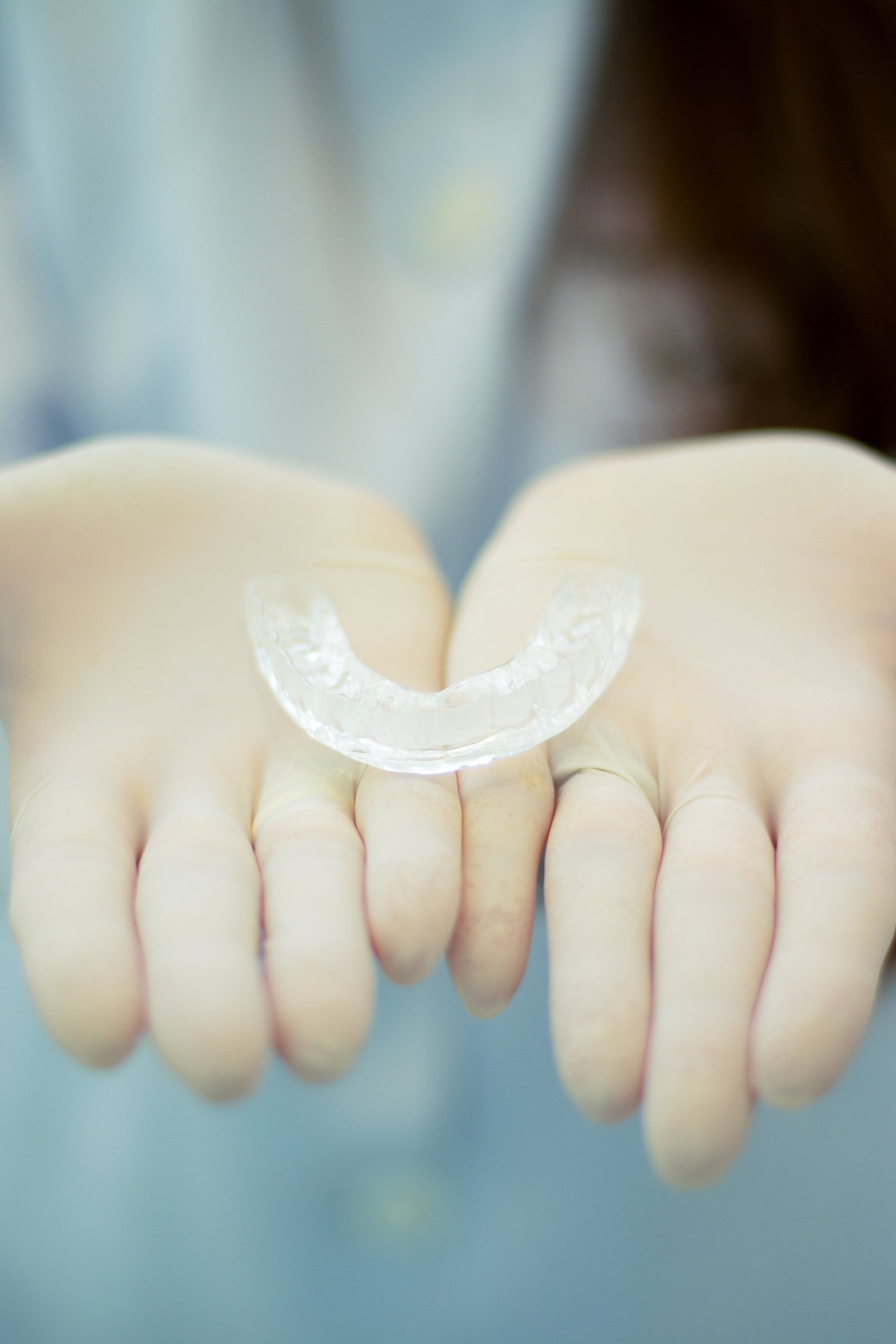 dentist holding clear aligners | Invisalign in Charlotte NC 28208