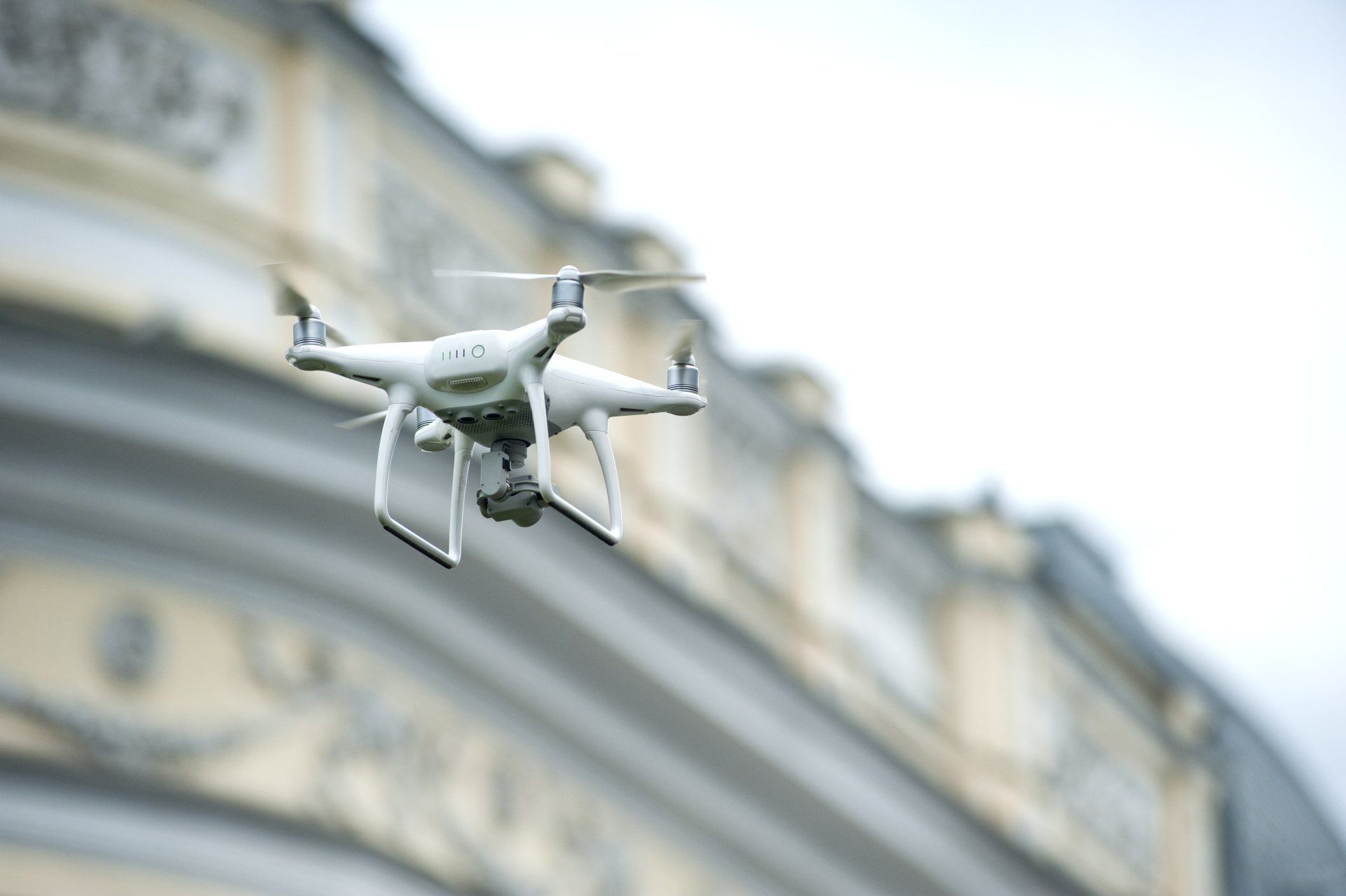 A drone is flying in front of a building.