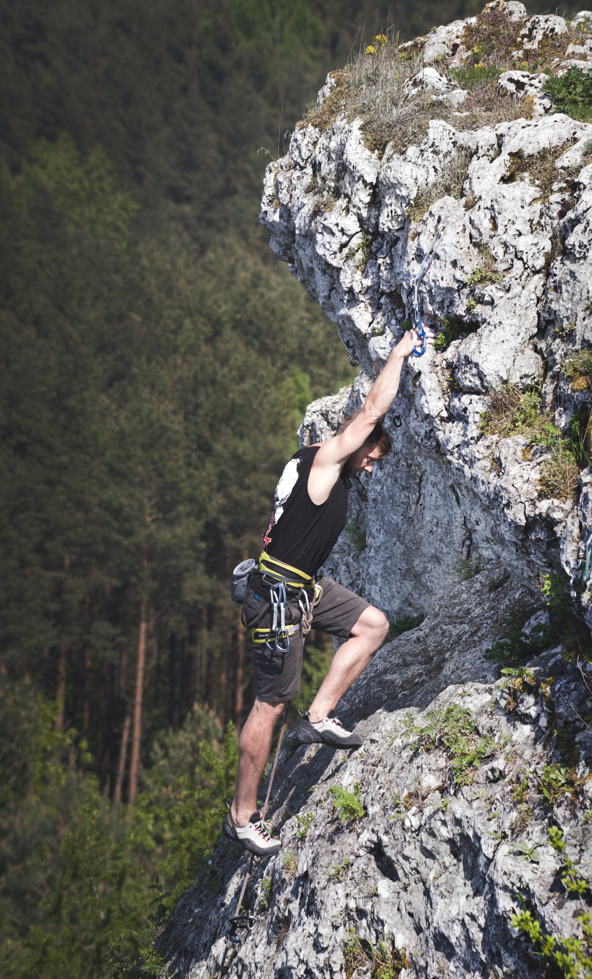 A young male rock climbing.