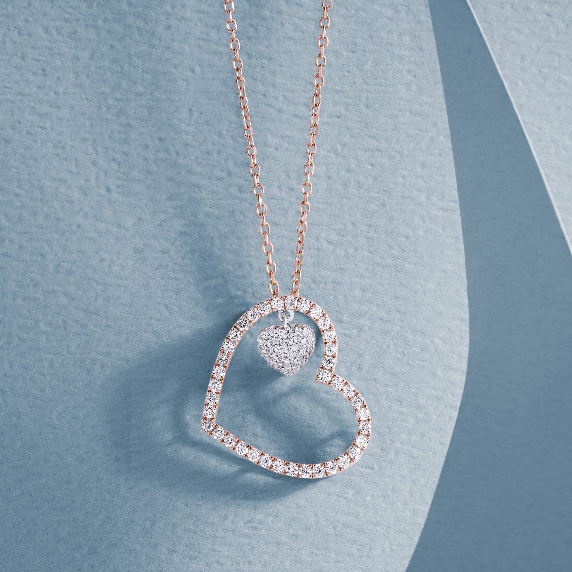 A necklace with a heart shaped pendant on a chain