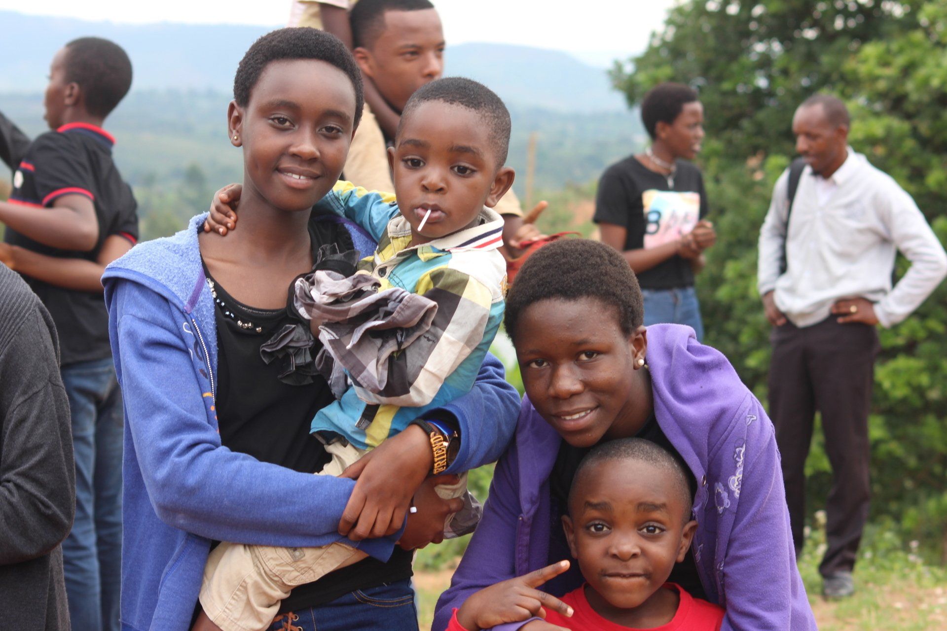 a group of people posing for a picture with a woman holding a child