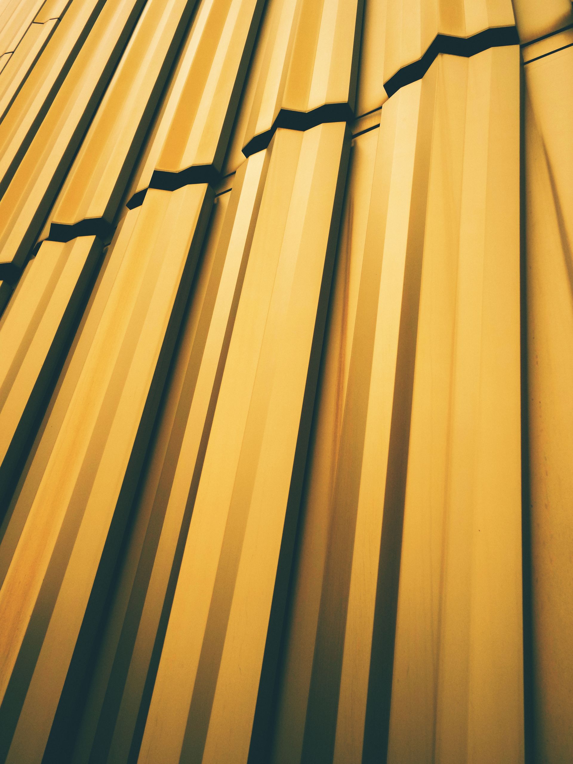 A close up of a yellow curtain on a building