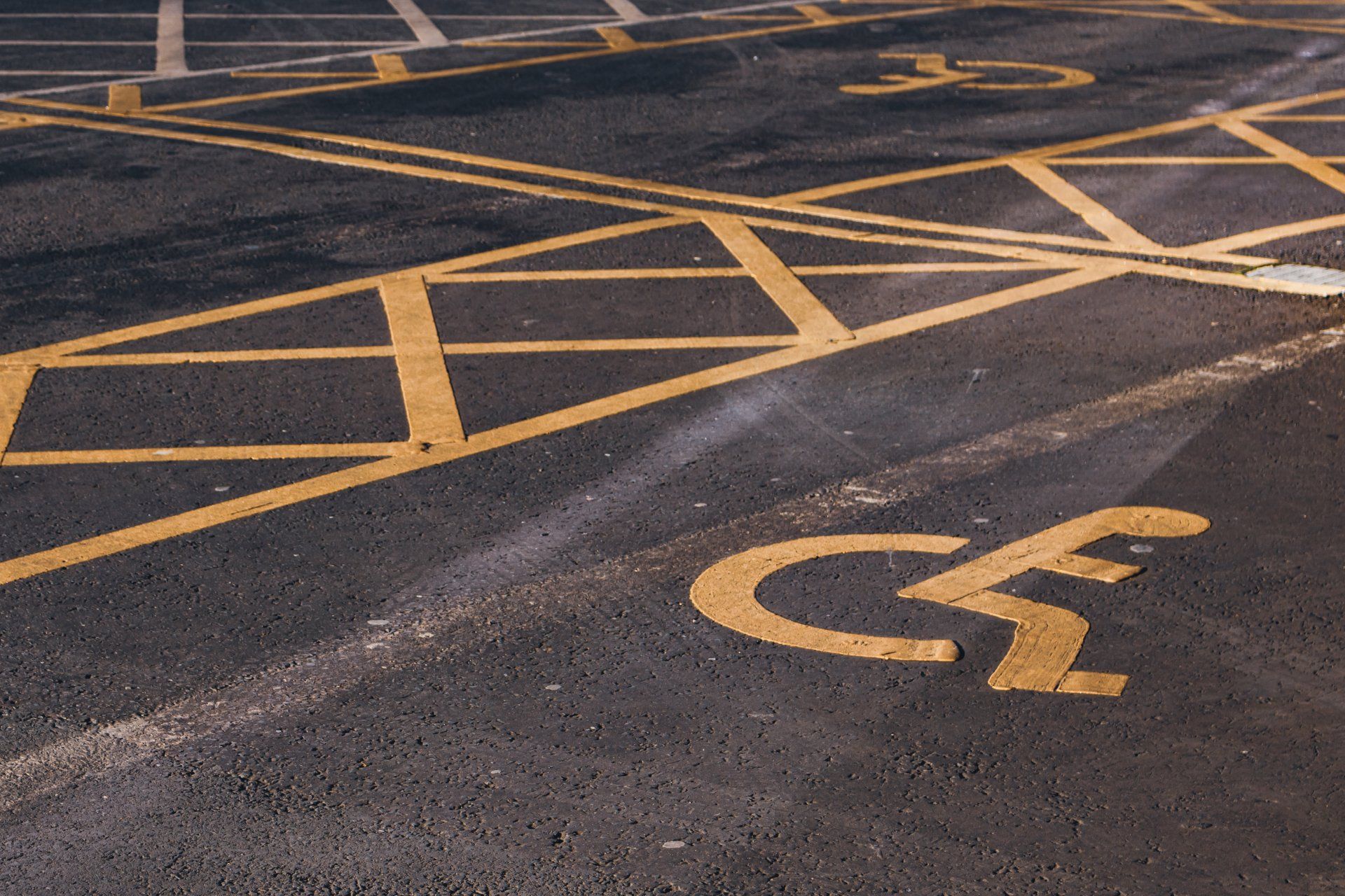 A handicapped parking spot is painted on the road