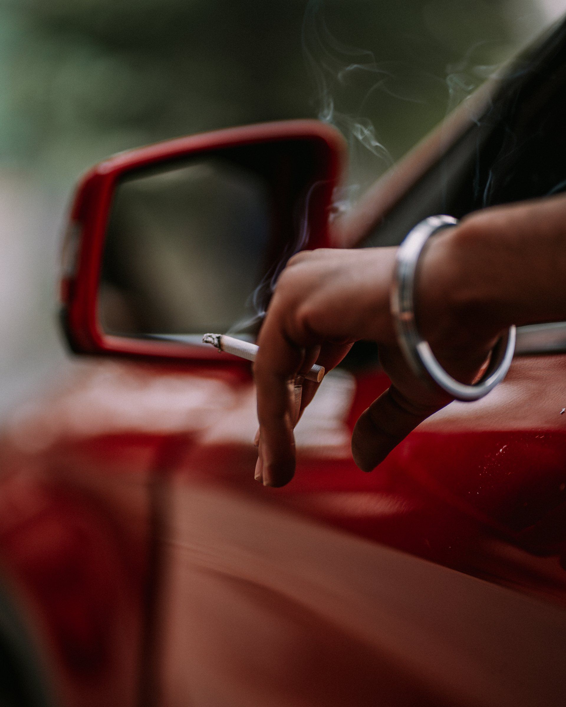 a person smoking in their car