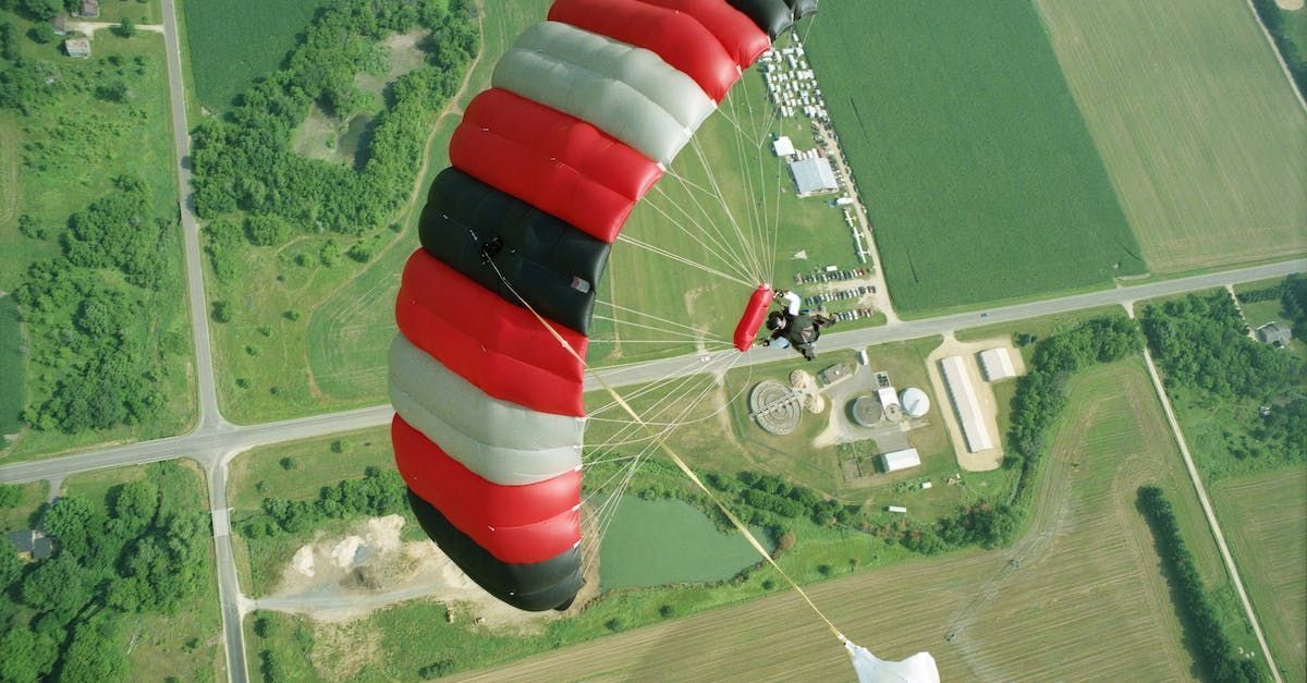 skydivers descending to the ground with a parachute 