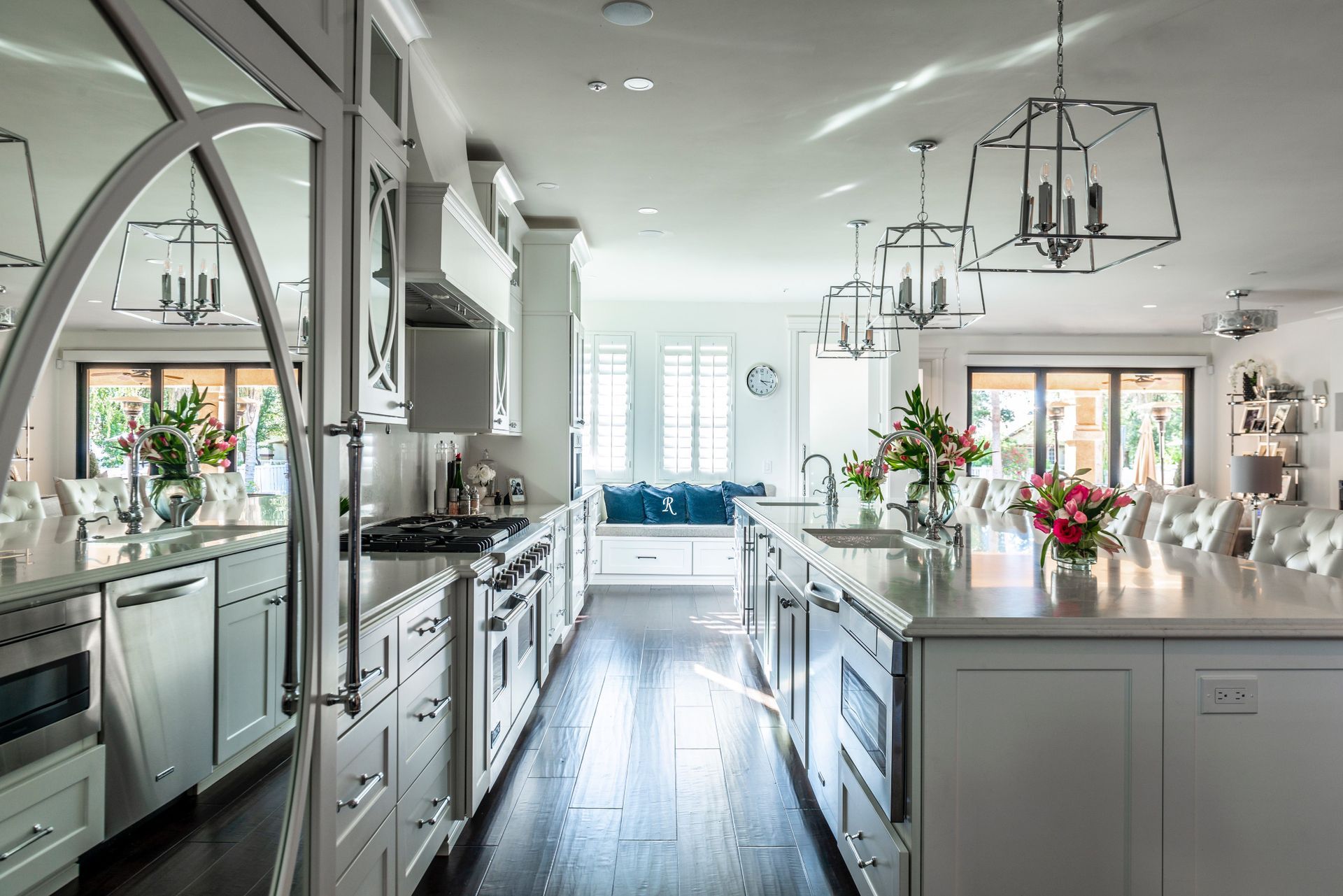 a kitchen with white cabinets and stainless steel appliances and a large island .