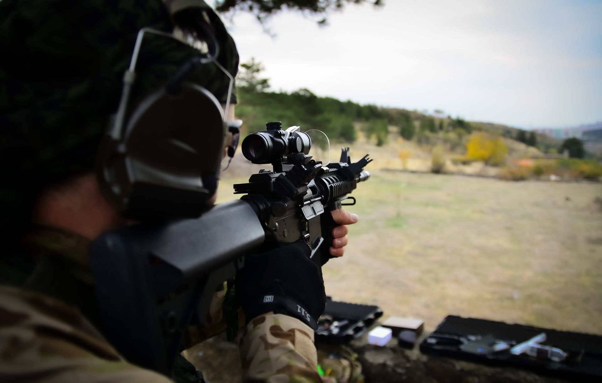 man aiming rifle at shooting range