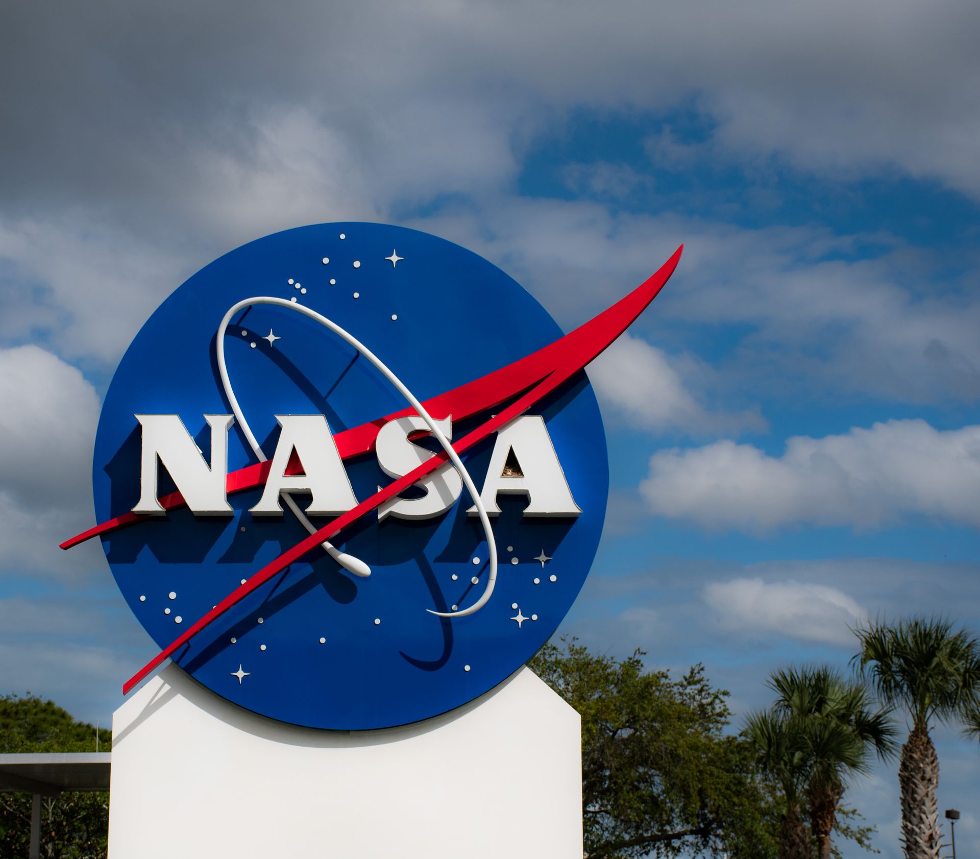 A large nasa sign against a cloudy sky