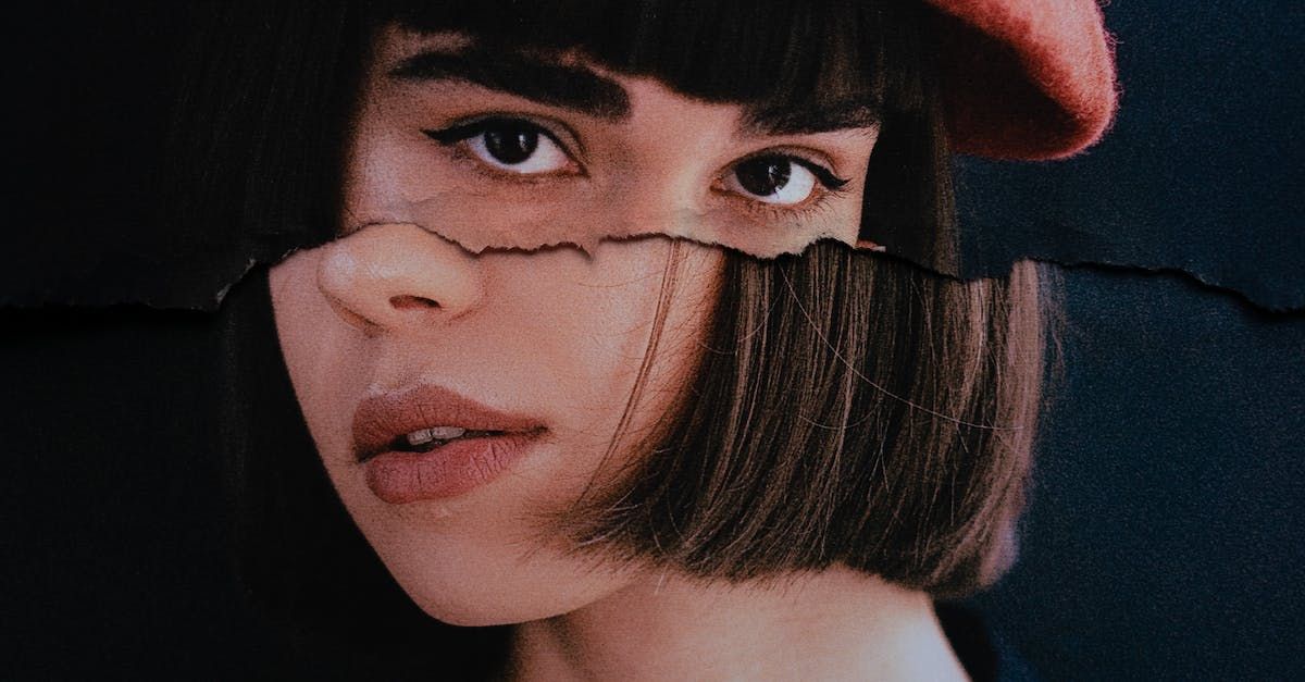 A close up of a woman 's face with a hat on.