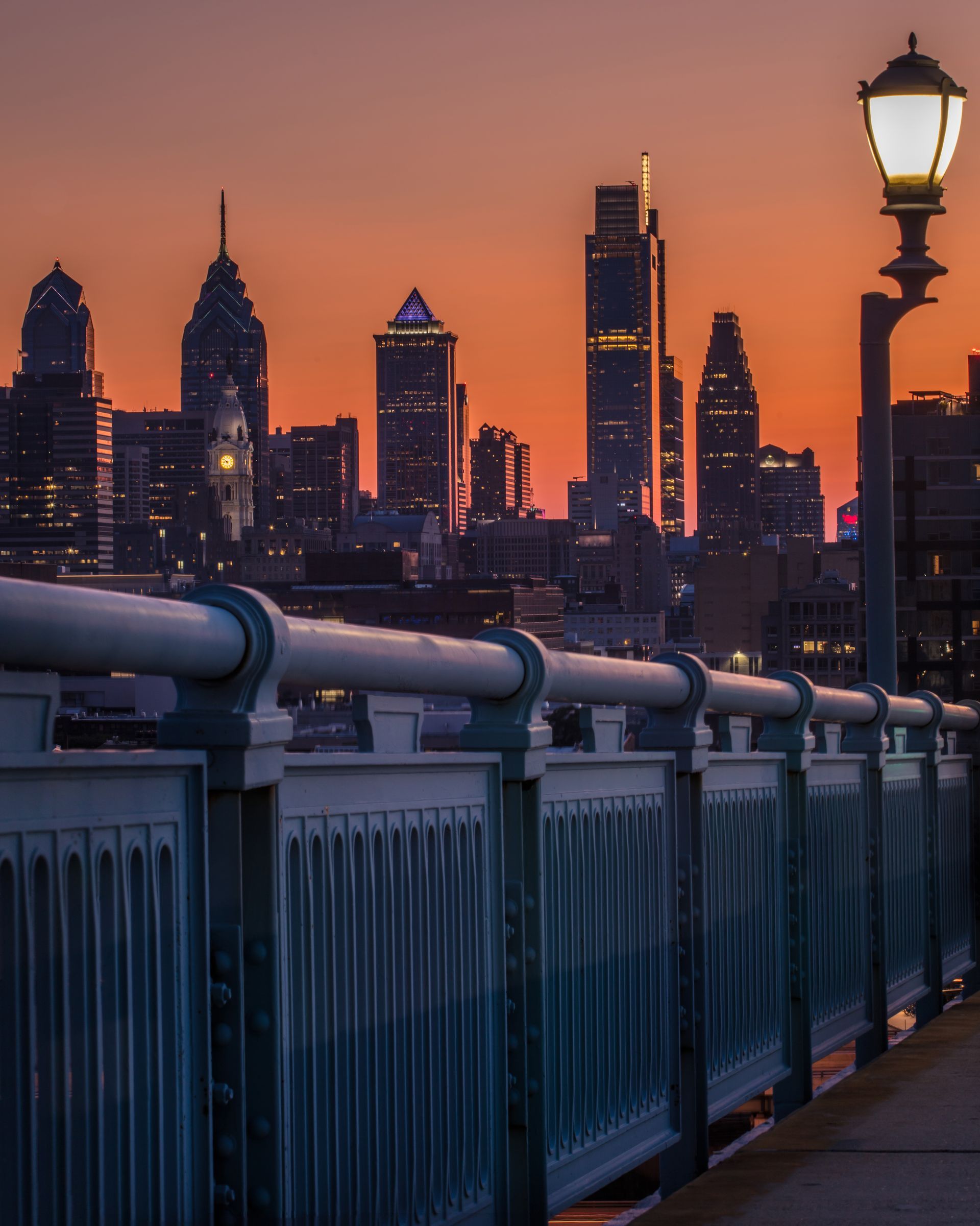 A bridge with a city skyline in the background