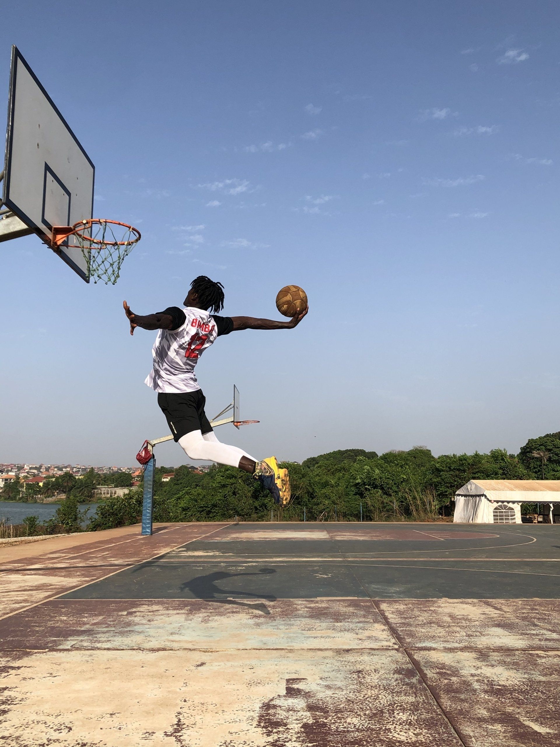 basketball player jumping high to make a hoop