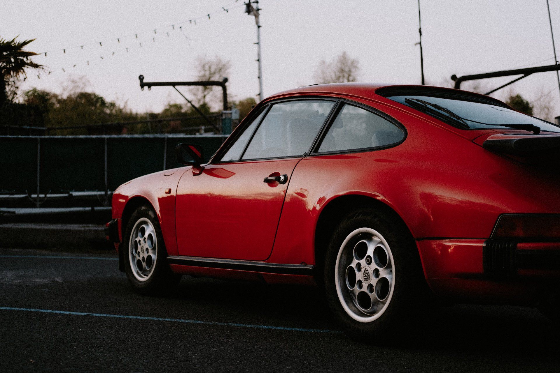 A red porsche is parked on the side of the road. | Euro-Tech Motors