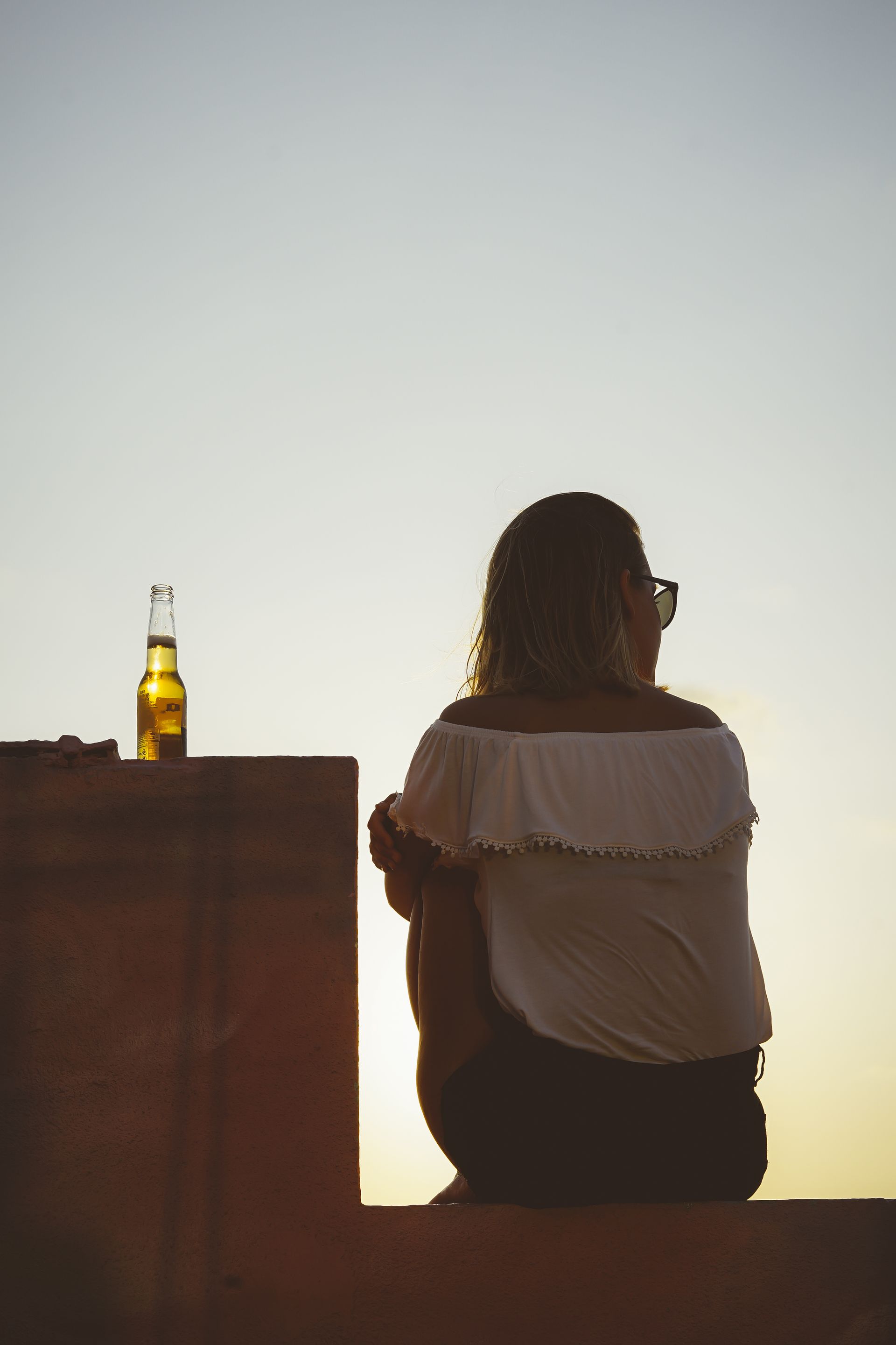 Woman sitting with drink next to her