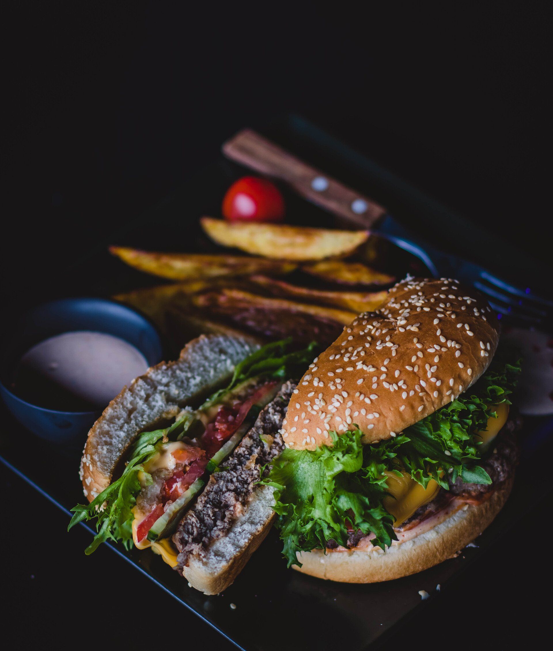 A close up of a hamburger and french fries on a table.