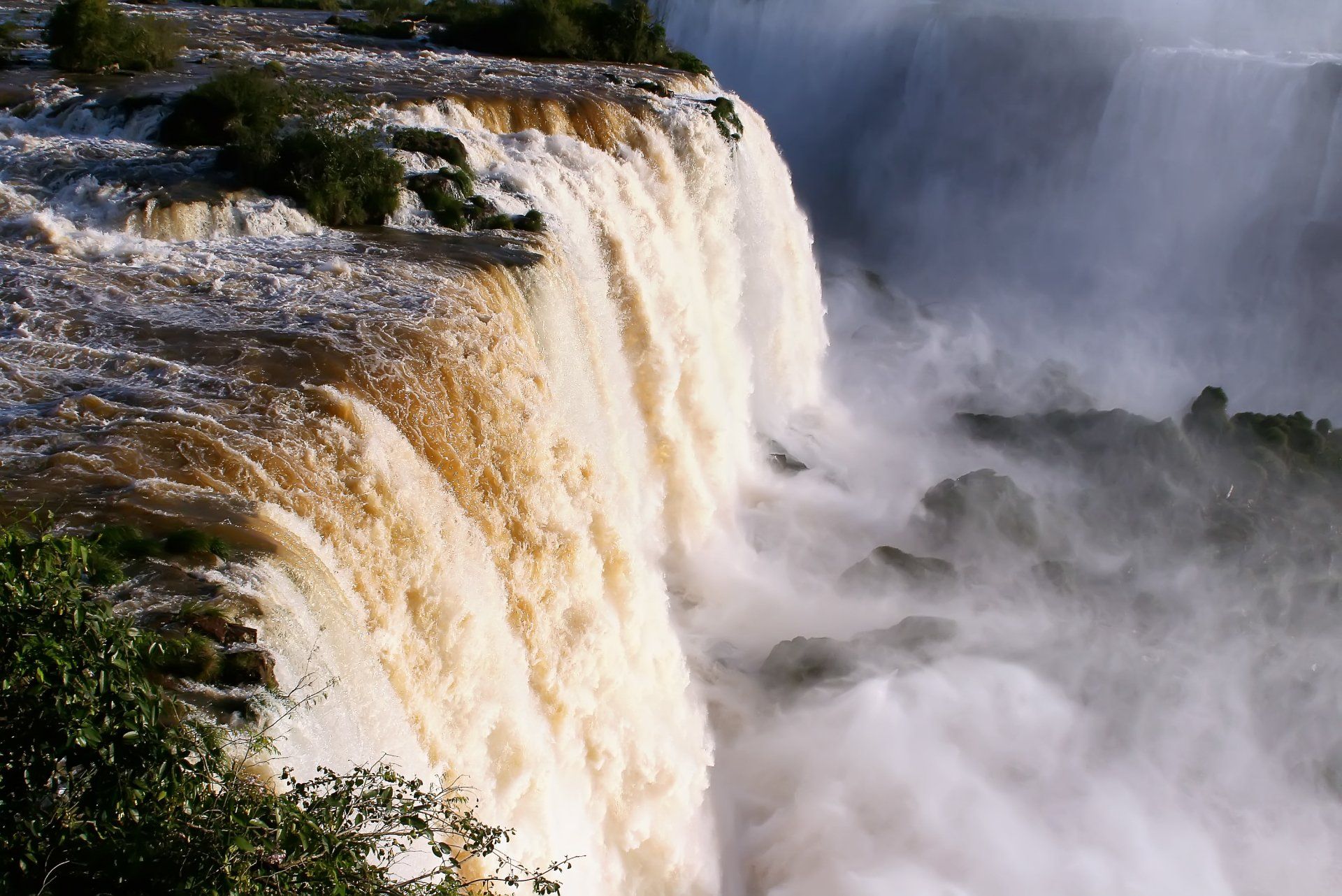 Una cascada con mucha agua bajando por ella.