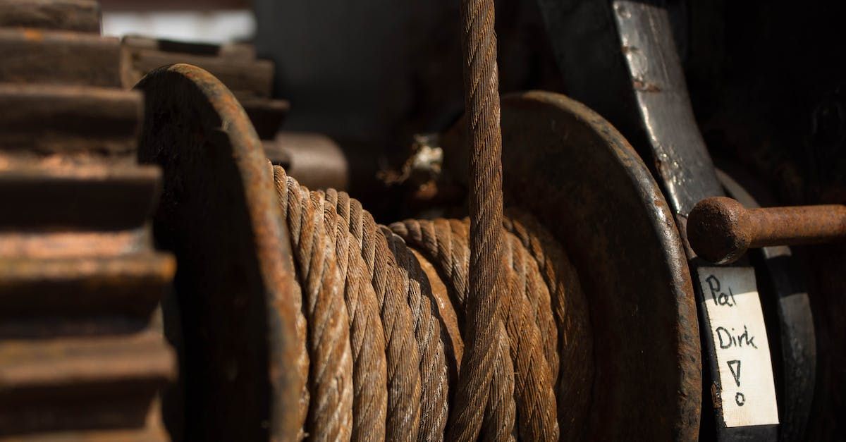 A close up of a rope on a wooden spool.