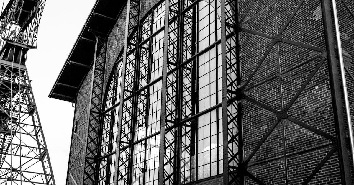 A black and white photo of a building with a lot of windows.