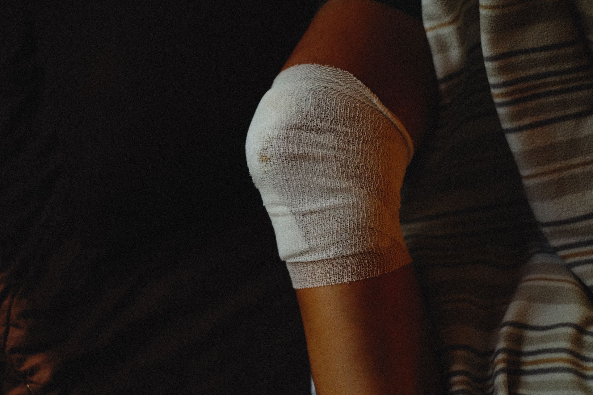 A person with a bandage on their knee