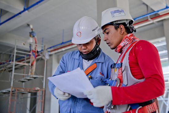 Workers discussing masonry project