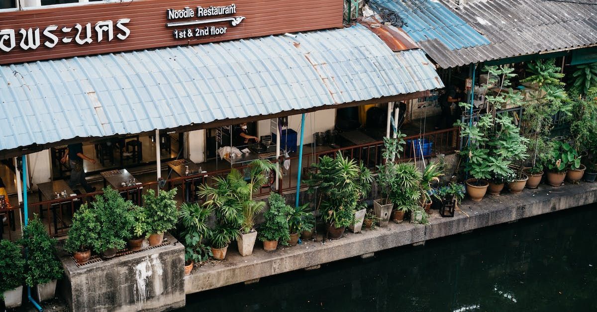 A Thai Noodle Restaurant sits along a waterway in Thailand