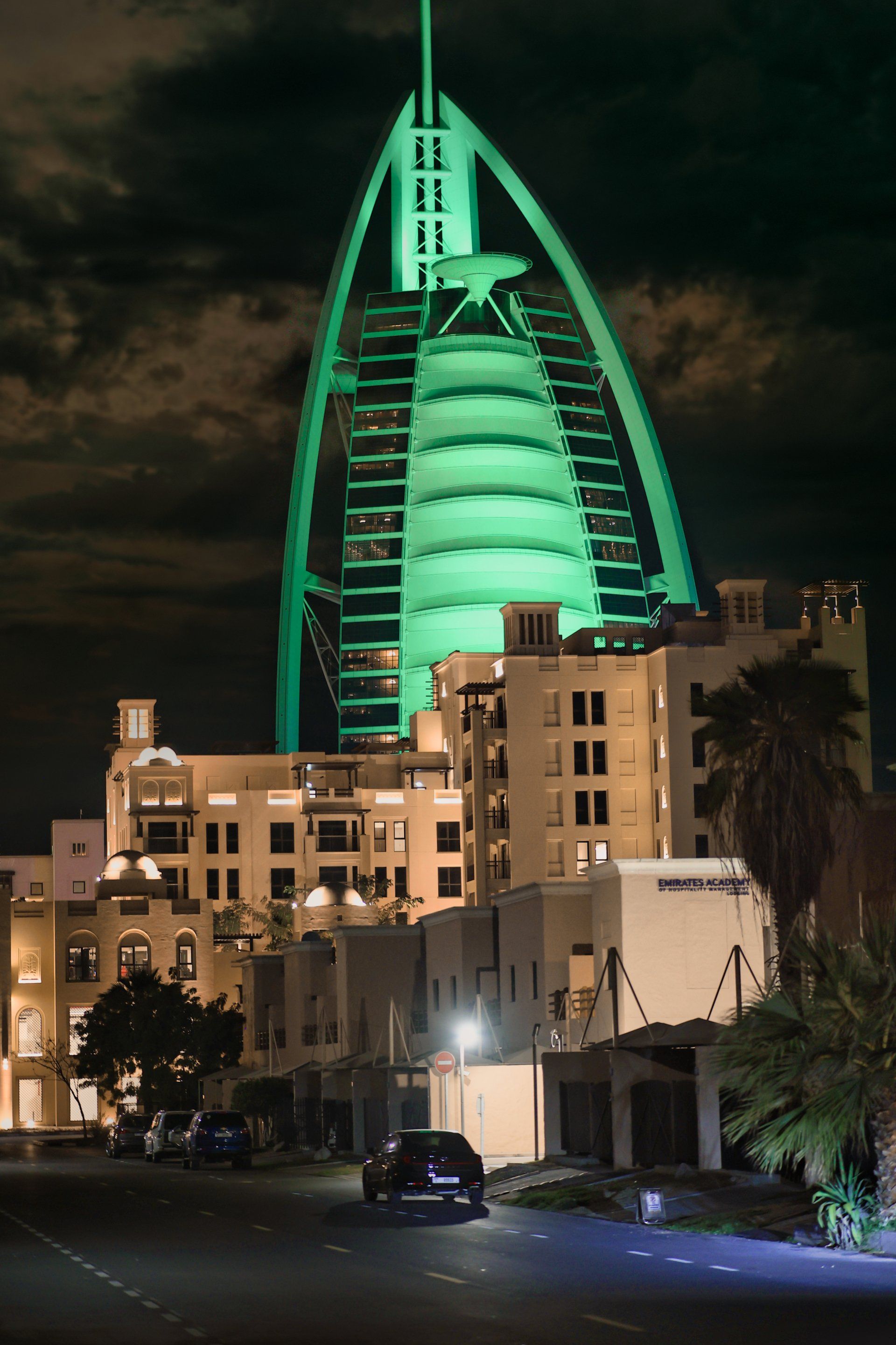 A large green building is lit up at night