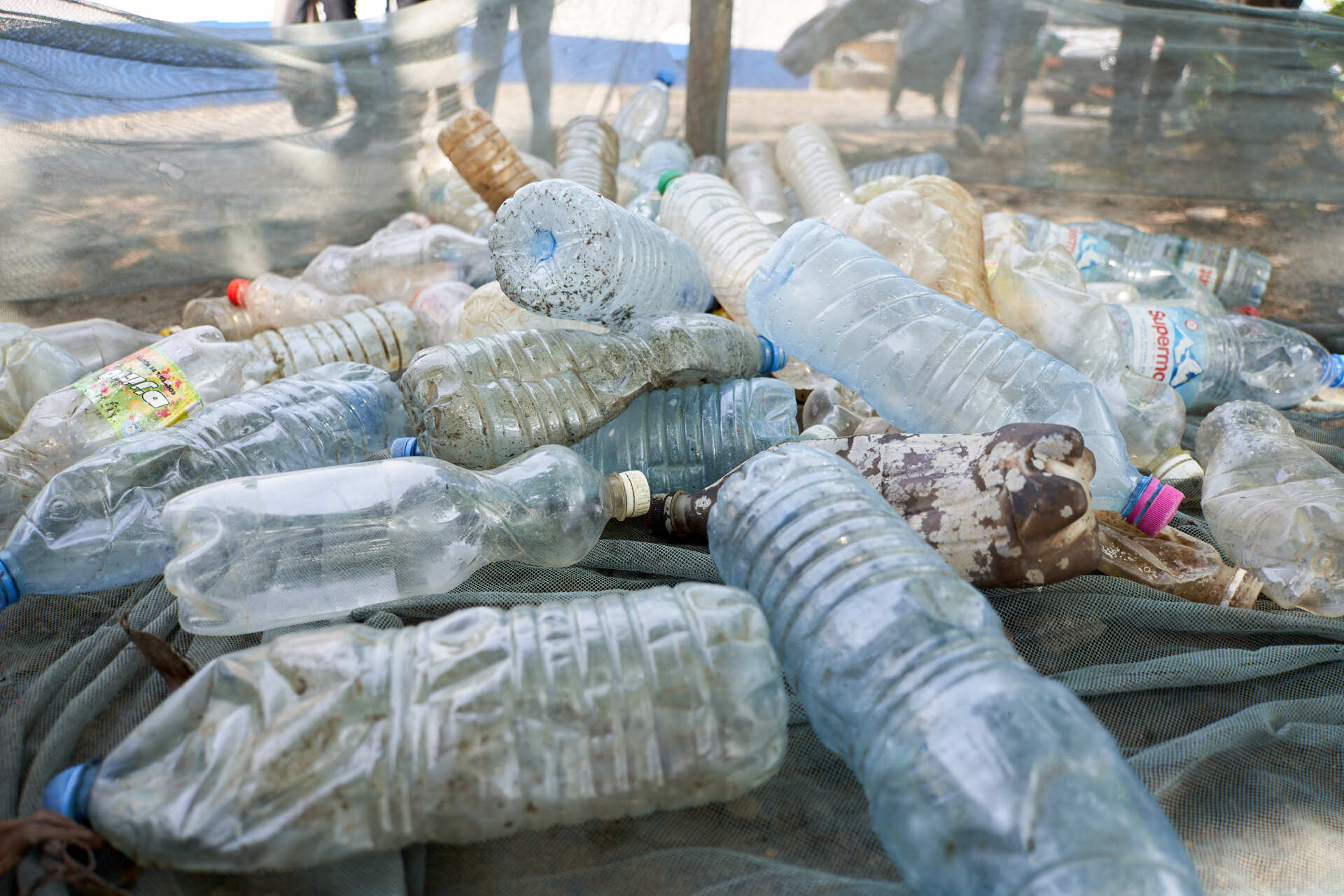 Close-up picture of multiple trash items, mostly plastic bottles