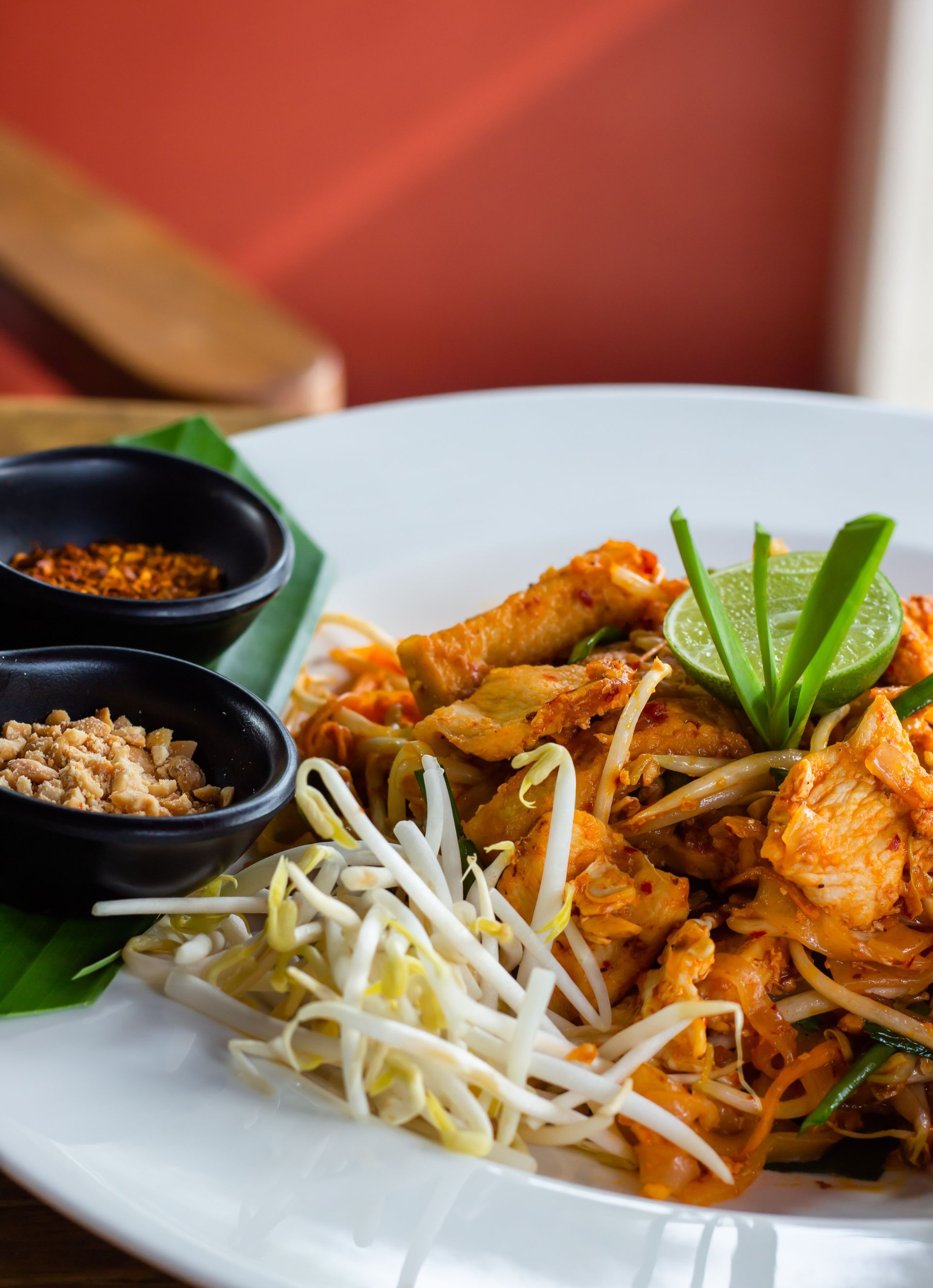 Front restaurant technology customer success Thai Heaven spicy chicken with bean sprouts and spices on white plate