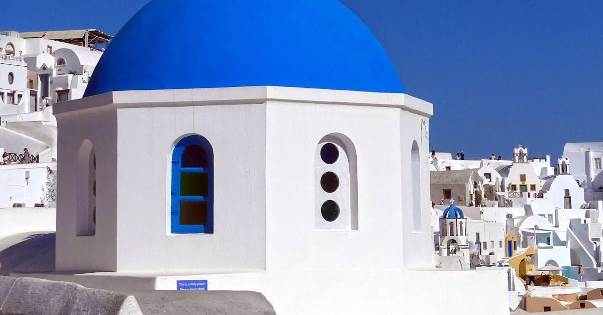 A white building with a blue dome on top of it.