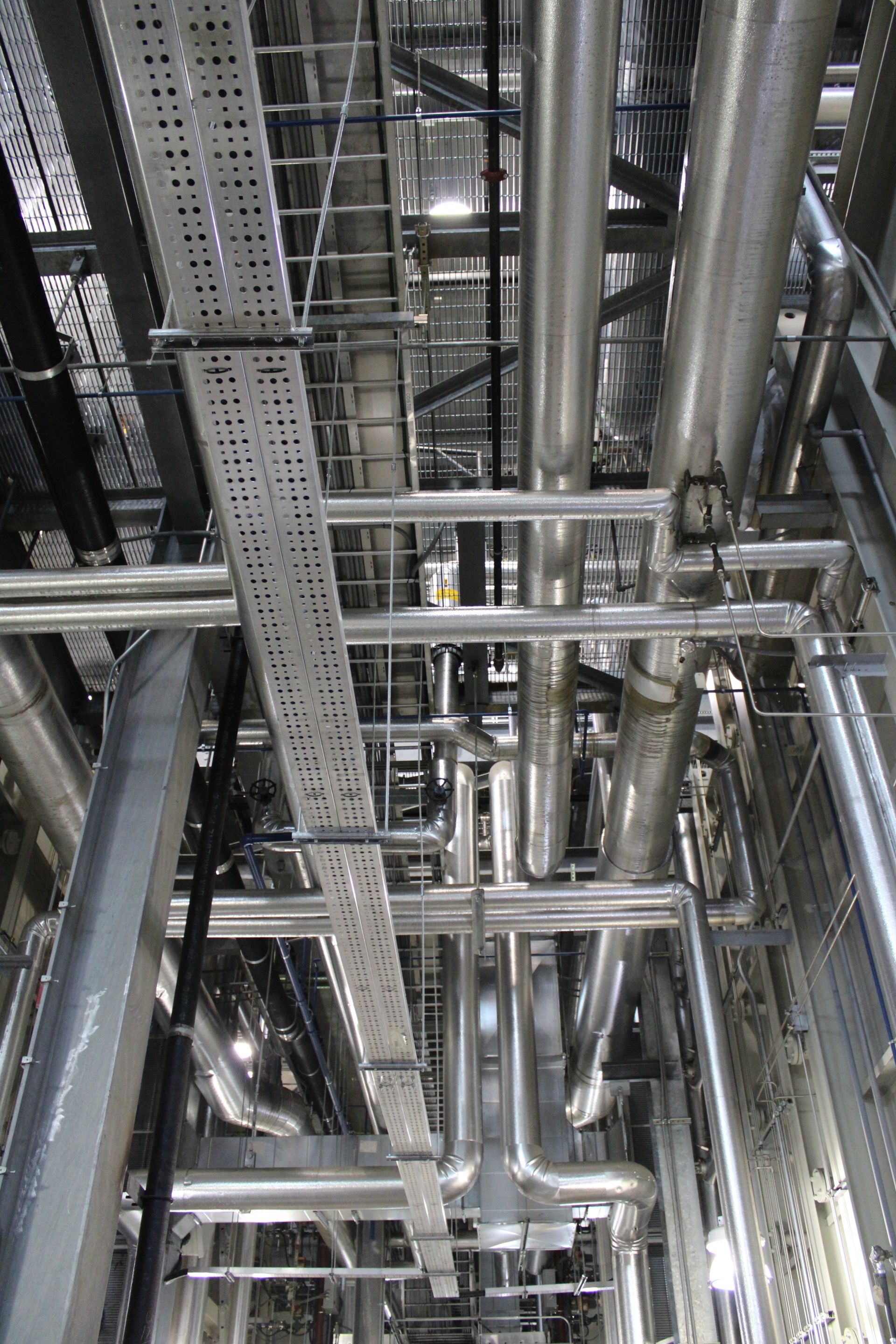 A woman is sitting on a couch holding a remote control.
