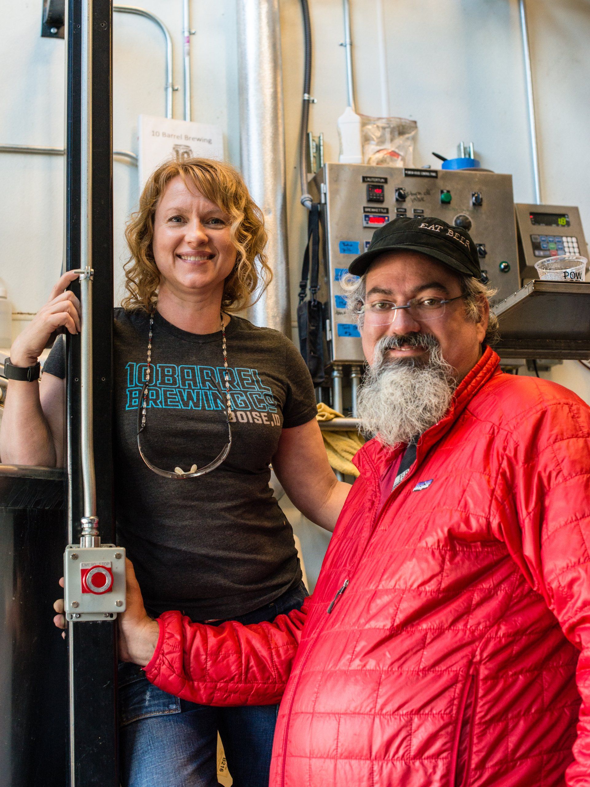 A man and a woman are standing next to each other in a kitchen.